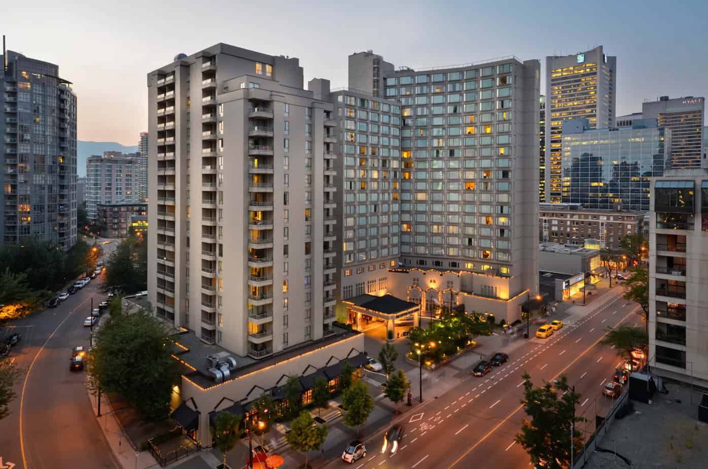 Outdoor arial view of The Sutton Hotel on an diagonal angle. The picture was taken during sunset so the lights are turned on down below. The Sutton Hotel is a beautiful hotel to stay in Downtown Vancouver.